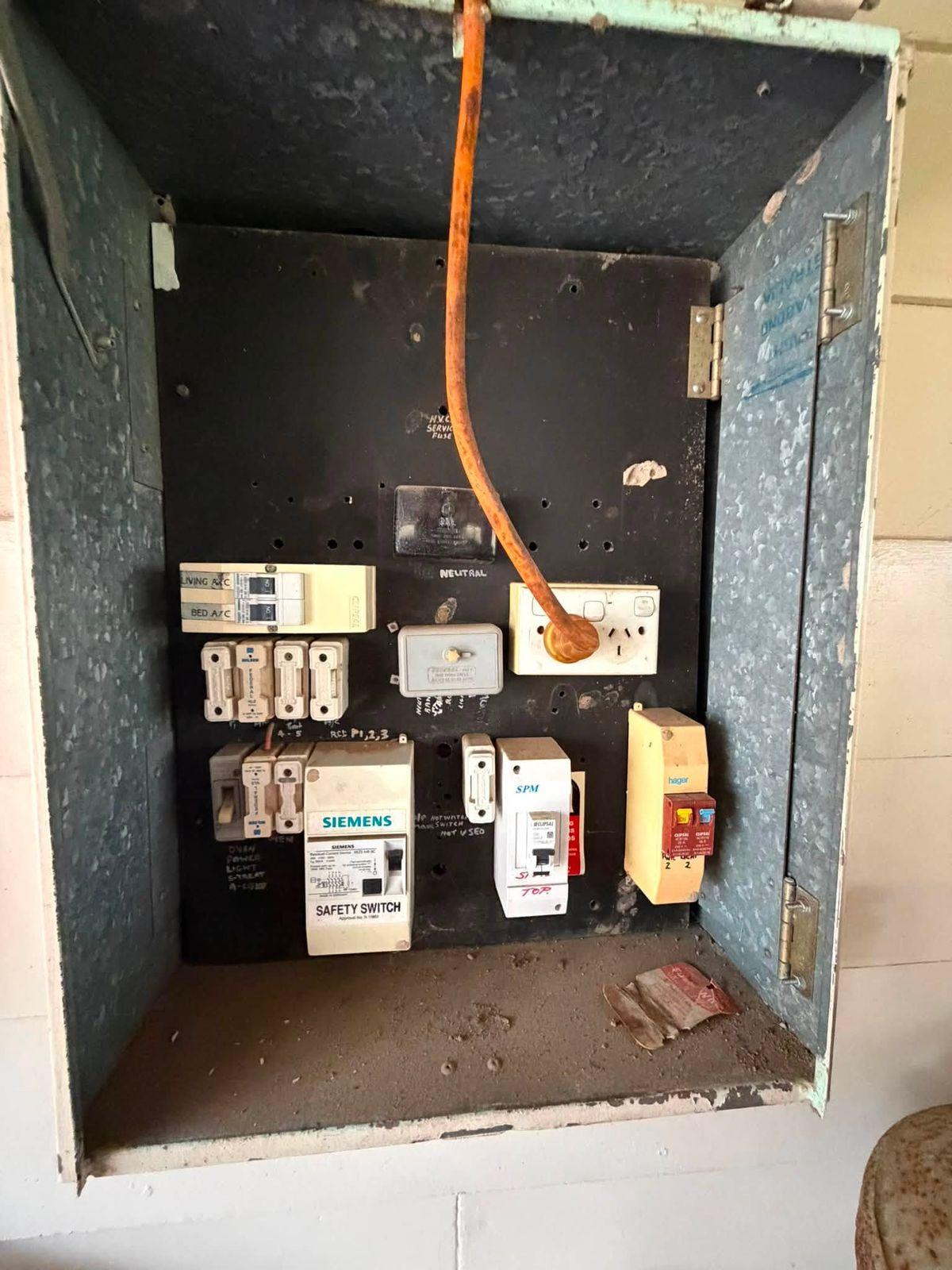 Old switchboard with a single safety switch and mixed fittings, before the upgrade